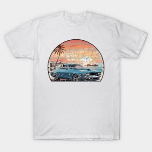 A muscle car cruisingon a coastal road during sunset T-Shirt